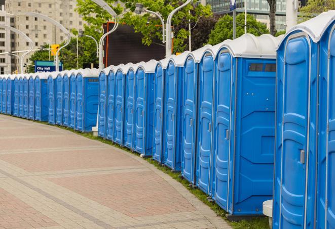 a row of sleek and modern portable restrooms at a special outdoor event in Mendon